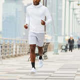 Man running on a city street wearing a white outfit thumbnail