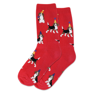 Child wearing red socks featuring a beagle with party hat decorating a Christmas tree in a living room with festive decor.