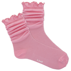 Pink socks with ruffled top on a white background, featuring the brand 'k.bell'.