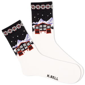White socks with a navy and red winter snowy scene containing mountains and a house.