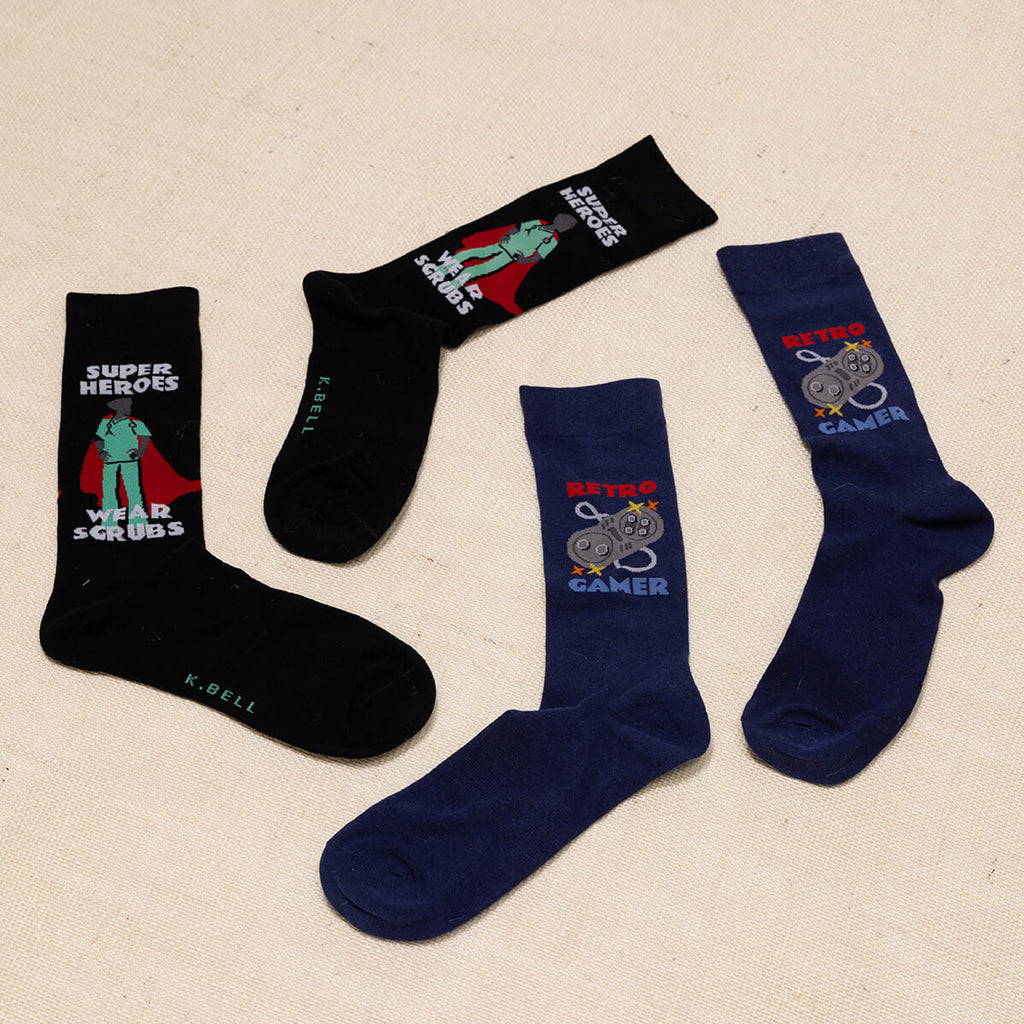 Two pairs of socks with superhero and gaming designs on a beige background