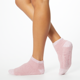Person wearing pink two-toned tonal fuzzy Dr. Scholl's soothing spa socks.