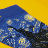 Blue socks with starry night design on a yellow background