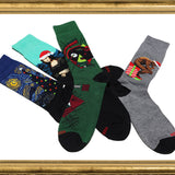 Four pairs of socks with artistic designs on a white background thumbnail