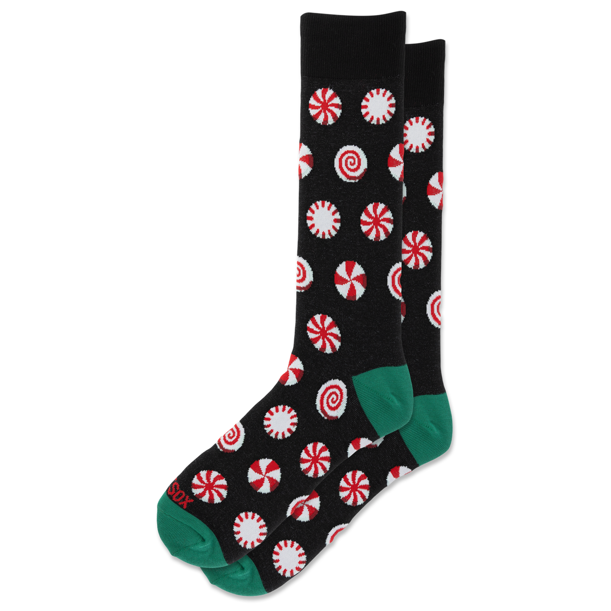 A pair of black crew socks with a red and white peppermint candy print and green toes and heels, displayed on a clean white background.