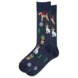A pair of navy blue crew socks featuring a festive Christmas pattern with wirehaired dogs wearing red scarves and green hats, decorated with white snowflakes and green pine trees.
