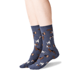 Blue socks with dog pattern worn by a person on a white background