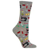 A single gray crew sock with a colorful pattern of sewing-themed icons including black sewing machines, red hearts, green scissors, yellow spools, and red thread spools, shown on a plain white background.