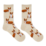 A pair of crew socks in a warm cream color, featuring an all-over print of Corgi dogs in orange, white, and brown, with small white bone motifs.