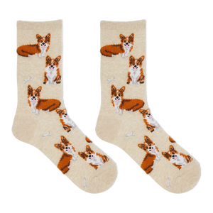 A pair of crew socks in a warm cream color, featuring an all-over print of Corgi dogs in orange, white, and brown, with small white bone motifs.