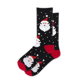 A pair of black crew socks with a festive Christmas pattern featuring Santa Claus faces, red heels and toes, and white polka dots, displayed on a clean white background.