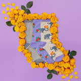 Pair of socks with elephant design surrounded by yellow flowers on a purple background thumbnail