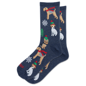 A pair of navy blue crew socks featuring a festive Christmas pattern with Jack Russell Terrier dogs wearing red scarves and green hats, decorated with snowflakes and a small Christmas tree.