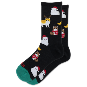 A pair of black crew socks with a repeating pattern of cute cats dressed in winter outfits, including Santa Claus and a reindeer, with a green toe cap and heel.