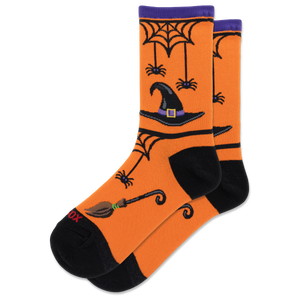 A pair of orange crew socks with a Halloween theme, featuring black heels, toes, and cuffs, decorated with a witch's hat, broomstick, spiderwebs, and spiders.