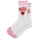 A pair of white crew socks with pink stripes at the top and pink toes/heels, featuring a red graphic of a lollipop and the text 'I'M A Sucker FOR YOU' on the front.