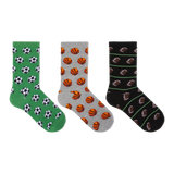 Three pairs of crew socks displayed side by side on a plain white background. The left pair is green with black and white soccer ball patterns, the middle pair is gray with orange basketball patterns, and the right pair is black with brown football patterns and thin green stripes. thumbnail