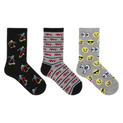 Three pairs of novelty crew socks displayed side-by-side on a plain white background. The left pair is black with colorful cartoon skateboarder prints.