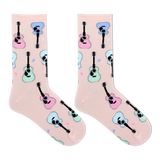 A pair of light pink crew socks with a repeating pattern of cartoon guitars in pastel pink, blue, and mint green, displayed on a clean white background. thumbnail