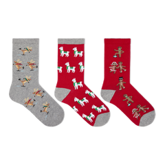 Three Christmas-themed crew socks displayed side-by-side on a plain white background. The left sock is heather gray with a pattern of skating reindeer.