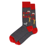 A pair of crew socks in dark heather gray with bright red cuffs, heels, and toes. The main body features the words 'CAT DAD' in red, alongside several cartoon cats in gray, white, and yellow.