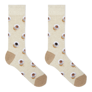 A pair of beige crew socks with a repeating pattern of coffee cups and saucers, featuring solid tan heels, toes, and cuffs, displayed on a clean white background.