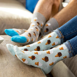 Person wearing socks with ice cream cone pattern on a couch thumbnail
