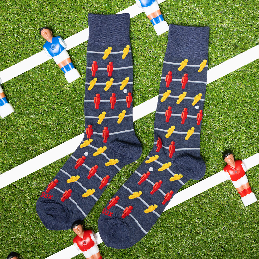 Pair of socks with foosball pattern on grass field