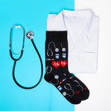 Black socks with medical-themed designs, a white lab coat, and stethoscope on a blue background