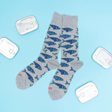 Gray socks with blue sardine fish pattern on a light blue background