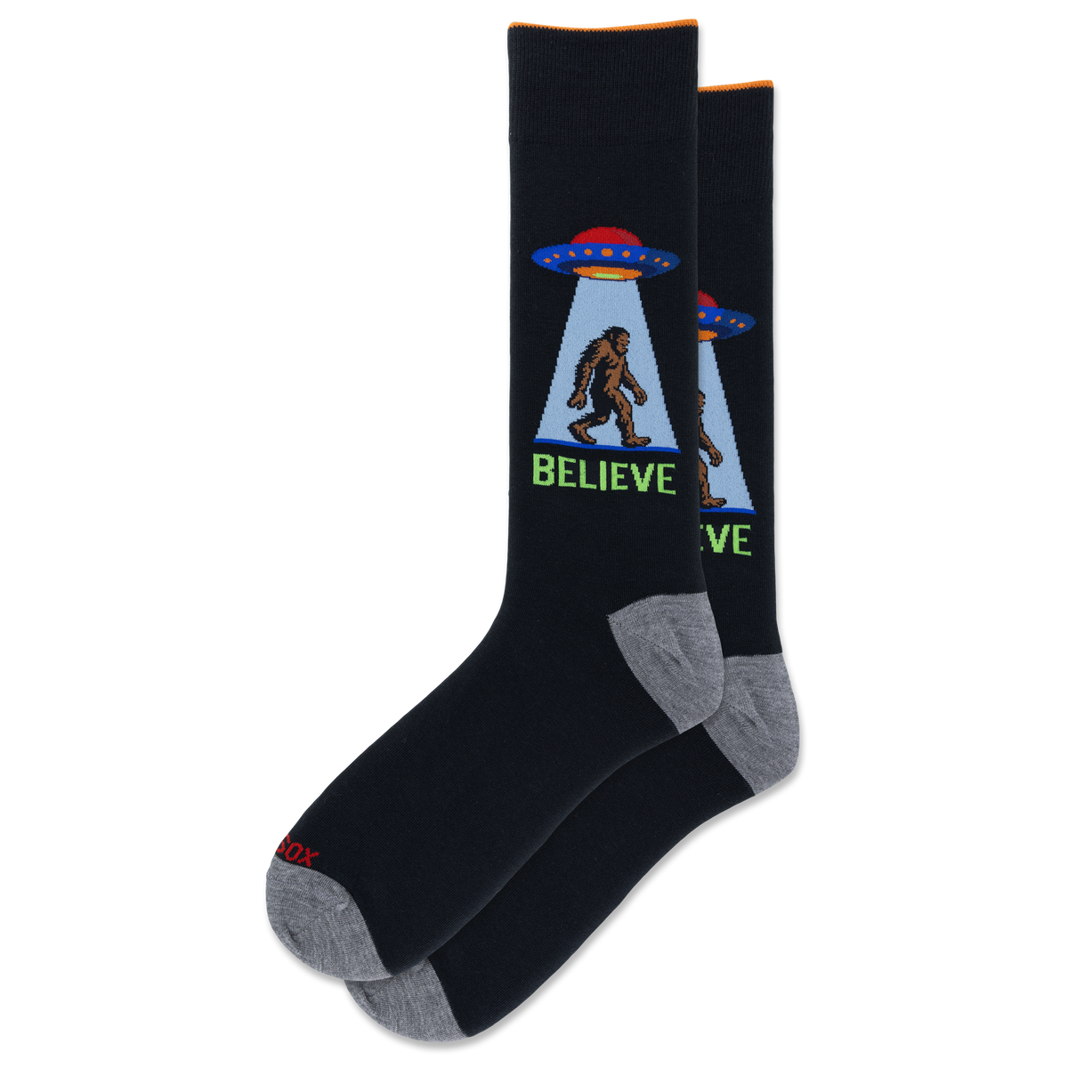 A pair of black crew socks with gray heels and toes, featuring a graphic of a Bigfoot silhouette under a UFO with the word 'BELIEVE' in green.