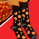 Black crew socks with a repeating pizza slice pattern, styled on a bright red background next to a sliced pepperoni pizza. thumbnail