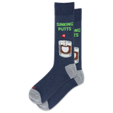 A pair of navy blue crew socks with gray heels and toes, featuring a graphic of a whiskey glass with a sinking putts flag and the text 'SINKING PUTTS' in green.