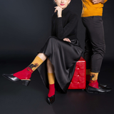 Man and woman posing together against a black background thumbnail