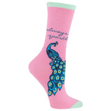 A single pink crew sock with a mint green cuff and toe, featuring a large blue peacock graphic and the words 'always sparkle' in dark blue script.