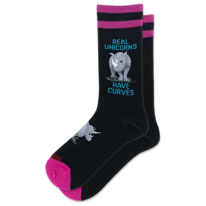 A pair of black crew socks with pink and magenta stripes at the top, featuring a gray rhinoceros graphic and the text 'REAL UNICORNS HAVE CURVES' in blue. The toes and heels are bright pink, and the brand name 'HOTSOX' is visible near the foot.