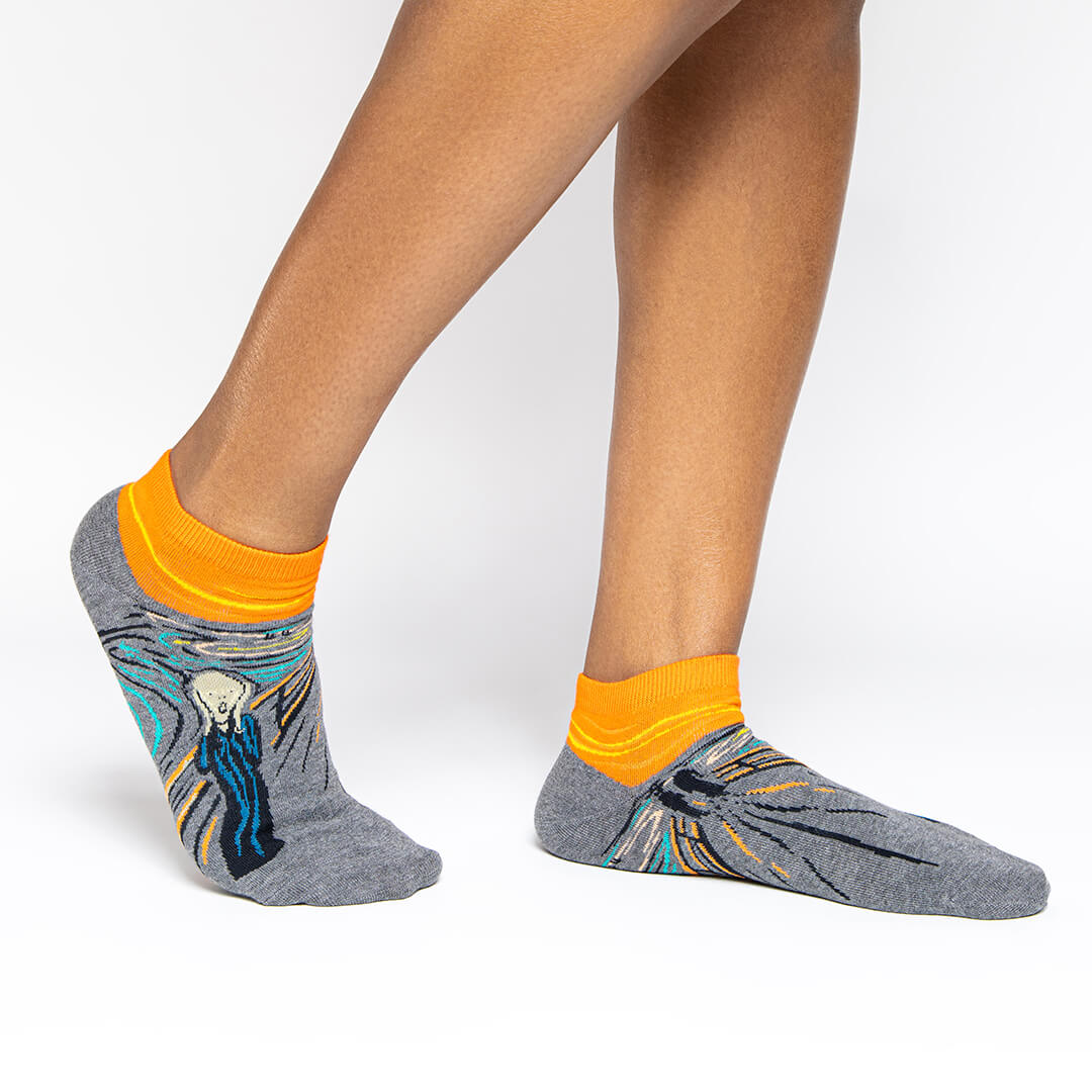 Gray and orange socks with a design inspired by 'The Scream' by Edvard Munch.