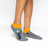 Gray and orange socks with a design inspired by 'The Scream' by Edvard Munch.