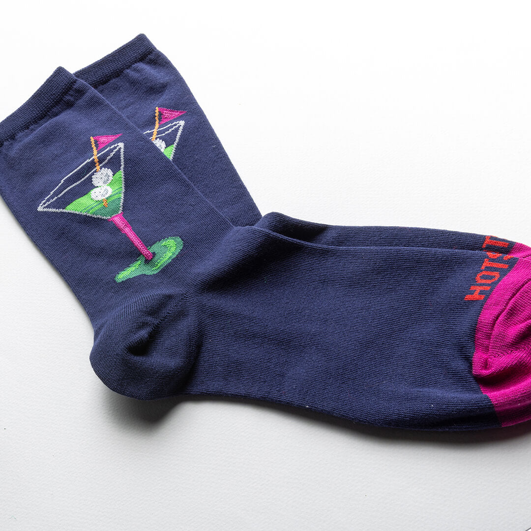 Navy blue socks with cocktail design and pink accents on a white background