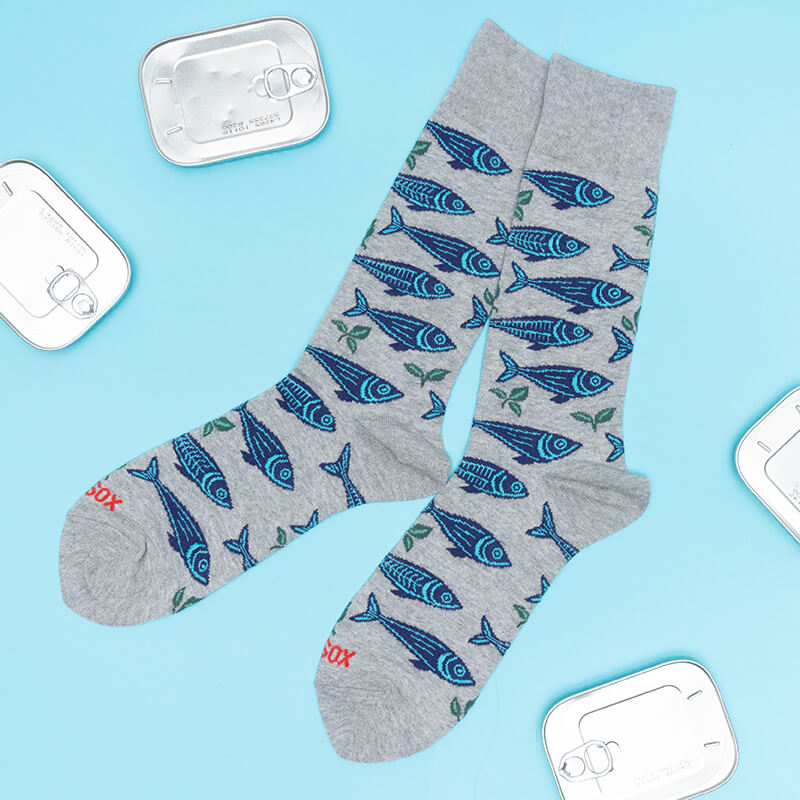 Gray socks with a blue sardine pattern on a light blue background