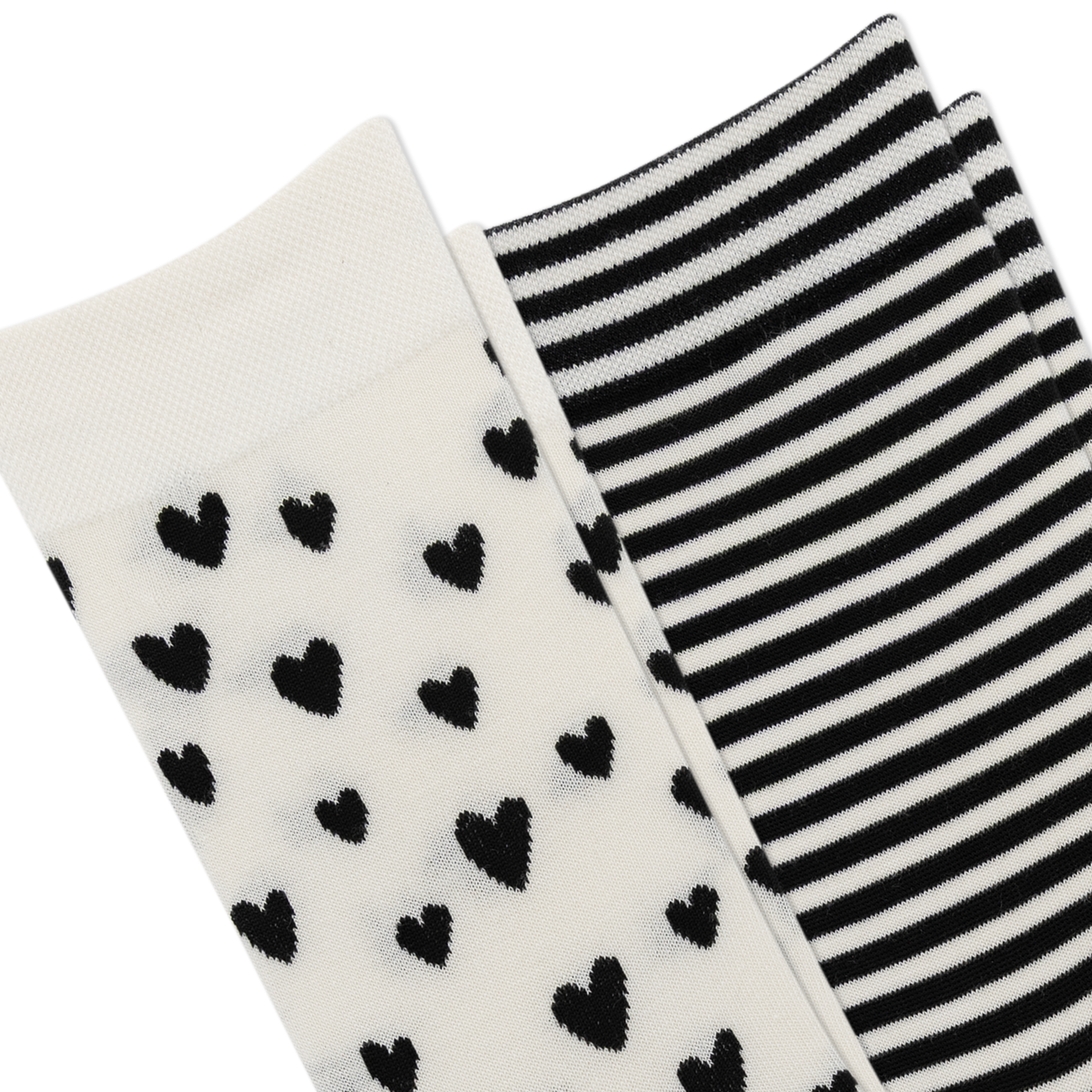 Two pairs of knit socks shown on a white background: one pair is off-white with scattered black heart motifs, and the other pair is black and white striped.