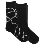 Two black crew socks with a white dotted pearl pattern, displayed on a clean white background. The brand name 'k-bell' is printed in white near the toe of the front sock.