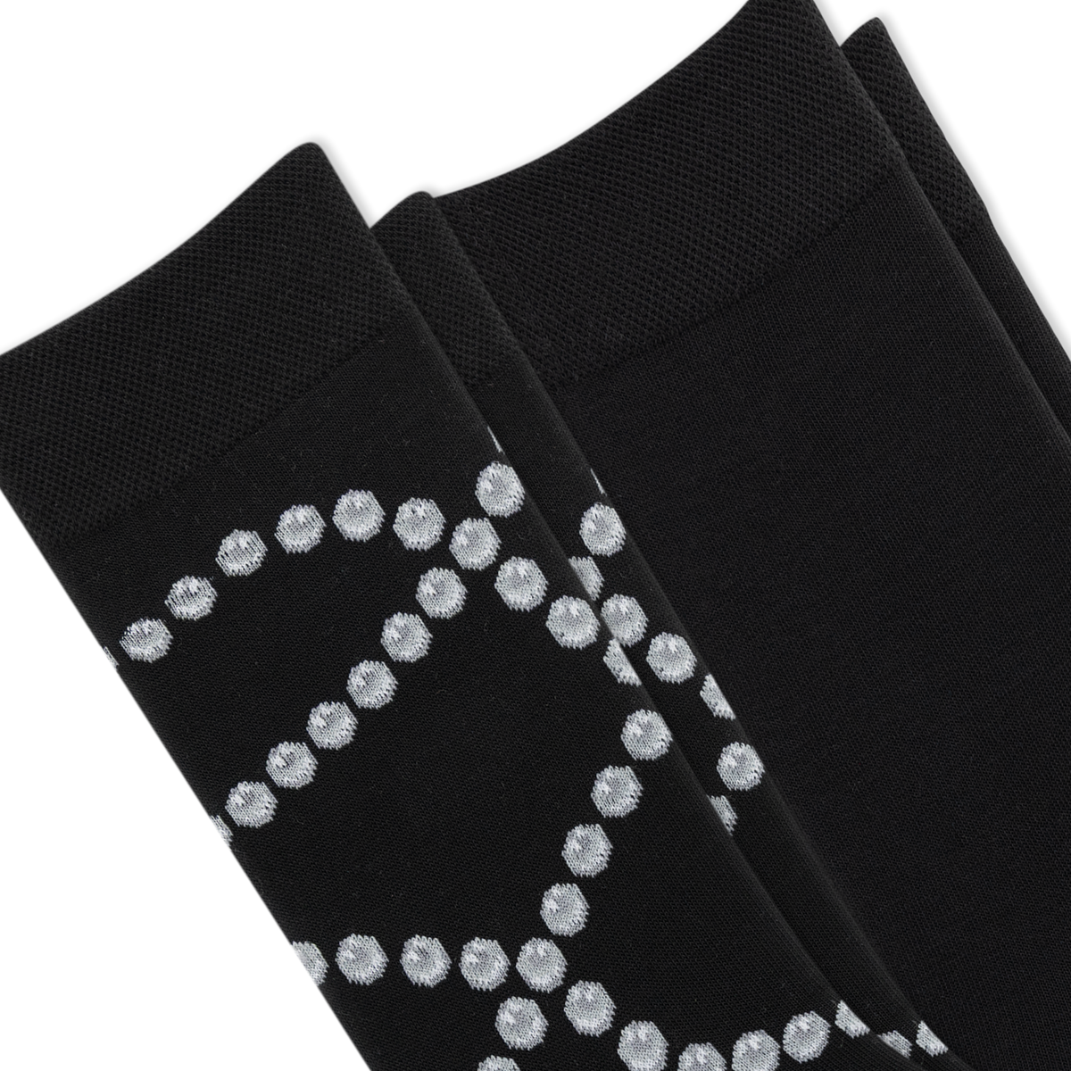 Two pairs of black dress socks stacked diagonally, featuring a textured knit pattern with a silver glittery geometric diamond design on the lower half.