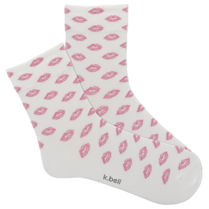 White socks with pink lip prints and 'k.bell' branding on a white background