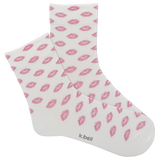 White socks with pink lip prints and 'k.bell' branding on a white background