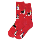 Child wearing red socks featuring a beagle with party hat decorating a Christmas tree in a living room with festive decor.