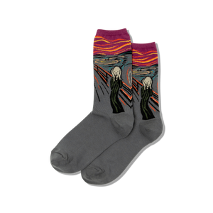 Gray socks with 'The Scream' colorful design on a blackboard easel with art supplies.