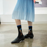 Person wearing socks with art-themed designs in a room. thumbnail