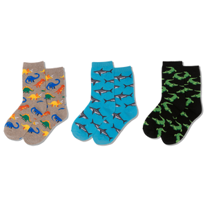 Gray socks with colorful dinosaur pattern worn by a child in denim jeans.