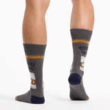 Gray socks with whiskey label design worn by a person on a white background thumbnail